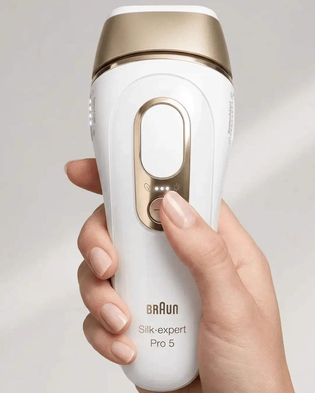 Hand hält den Braun Silk Expert Pro 5 mit aktiviertem SensoAdapt-Hautsensor